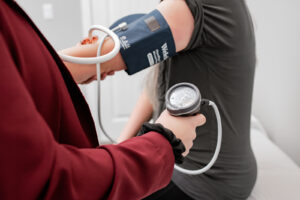 Naturopathic doctor taking patient's blood pressure