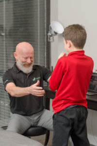Physiotherapist assessing child. Physiotherapy may be right for you.