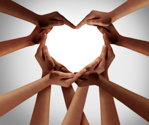 multicultural hands forming a heart representing emotional wellness 
